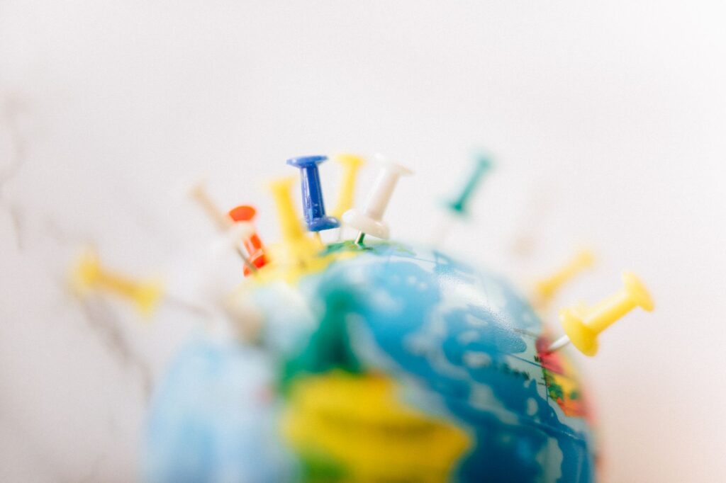 World map pinned on an office wall. Cover image for How Winning Global Brands Are Actually Built.