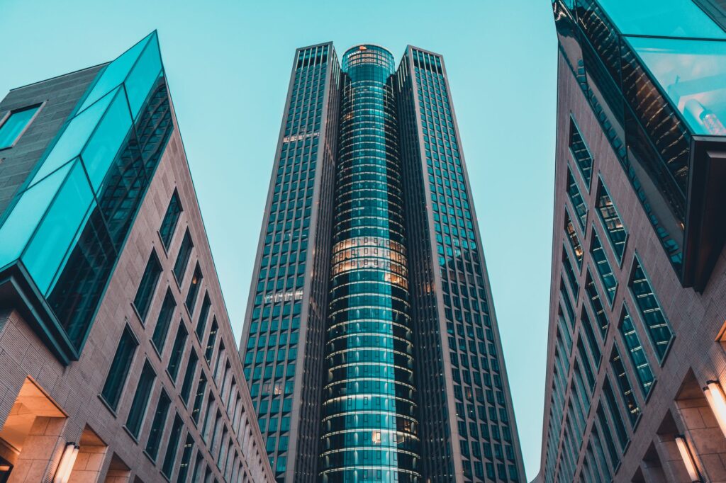 Modern office building glass facade from below. Cover image for Structure Follows Strategy in Global Marketing.