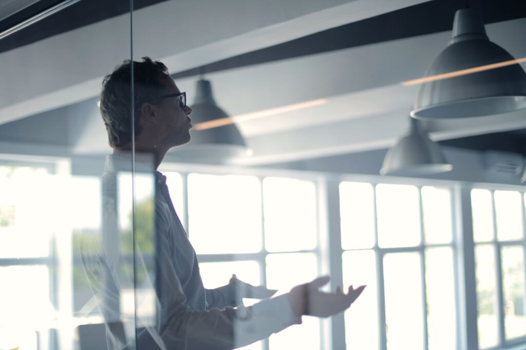 Businessman walking through a corporate lobby. Cover image for The Marketing Leader Who Operates Like a CEO.