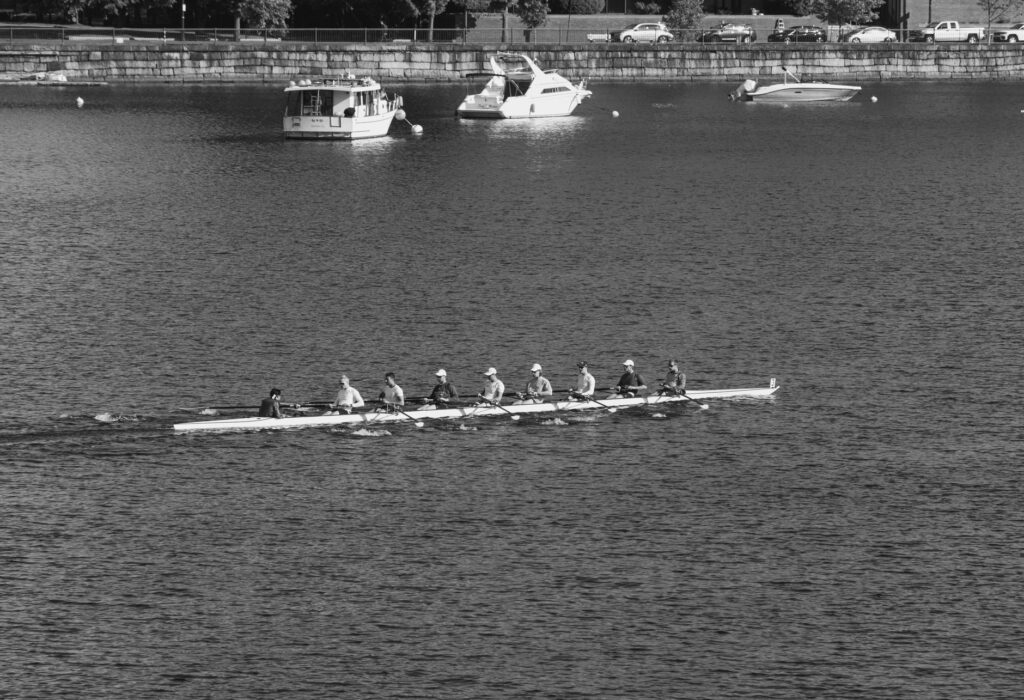 Rowing eight crew racing on a calm river. Cover image for Coordinated Agility, and Why Fanta Had Nothing to Say.