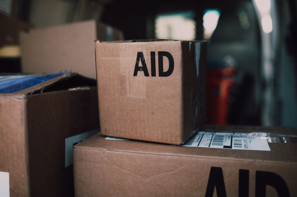 Humanitarian aid supplies stacked in a warehouse. Cover image for Lower the Price Instead: What a UN Agency Wants From a Corporate Partner Now.