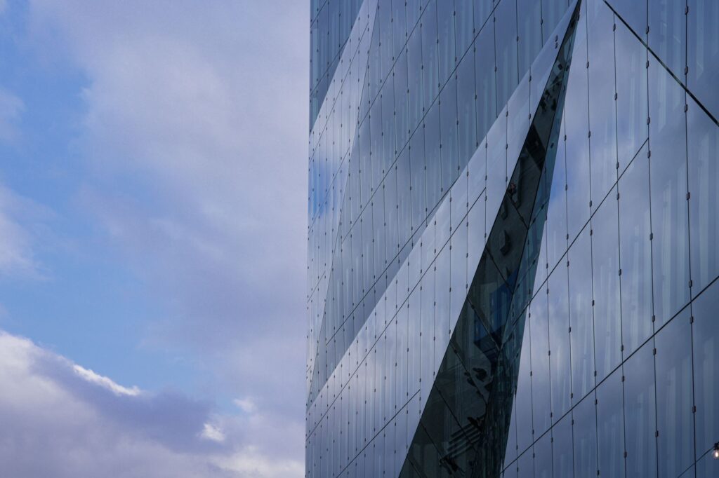 Two glass office towers standing side by side. Cover image for A Hundred Percent Separate and a Hundred Percent Integrated.
