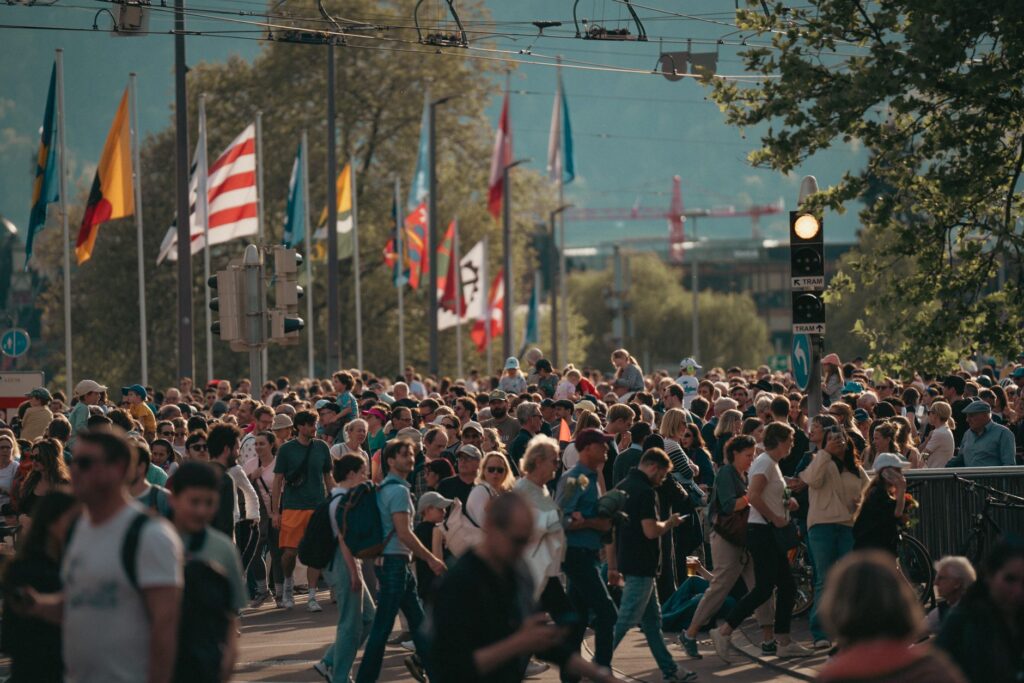 Crowd of people walking through a city street. Cover image for You Cannot Have Humanized Growth When Humans Are at Risk.