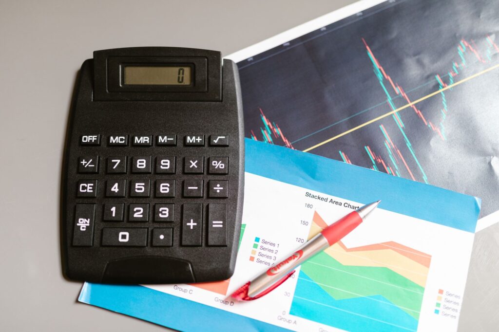 Financial report pages beside a calculator. Cover image for One in Seven: A CFO on Rewriting the Contract With Your Shareholder.